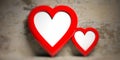 Two red heart shaped empty frames on faded wall background, copy space Royalty Free Stock Photo