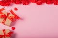 Valentines day and love concept. Two small gift box with small red heart and flowers on pink background Royalty Free Stock Photo