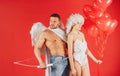 Valentines day lovely couple. Angel cupids. St Valentine concept. Girl and boyfriend with heart balloons and bow. Arrow
