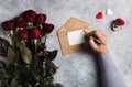 Valentines day man hand holding pen writing love letter with greeting card Royalty Free Stock Photo