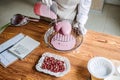 Valentines Day Marketing Ideas for Small Businesses. Confectioner chef make heart shape pink Mirror Glaze mousse cake