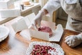 Valentines Day Marketing Ideas for Small Businesses. Confectioner chef make heart shape pink Mirror Glaze mousse cake