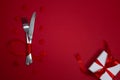 Valentines day meal background with red ribbon, hearts, fork, knife, white plate and napkin. Romantic holiday table Royalty Free Stock Photo