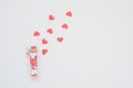 Valentines day minimal concept - isolated pink hearts with open glass bottle on white background