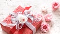 Valentines day and mothers day concept, red gift box with bow and roses on light wooden background