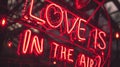 Valentines Day Neon vibrant red sign with phrase LOVE IS IN THE AIR and hearts