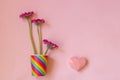 Valentines Day. Paper cup rainbow and gerbera, heart on soft pink background. The concept of gay pride, LGBT community, adoption Royalty Free Stock Photo