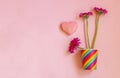 Valentines Day. Paper cup rainbow and gerbera, heart on soft pink background. The concept of gay pride, LGBT community, adoption Royalty Free Stock Photo