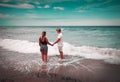 Beautiful couple in love walking on the beach holding hands. Royalty Free Stock Photo