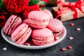 Valentines day pink cake macarons with red roses Royalty Free Stock Photo