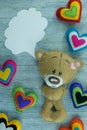 Valentines Day postcard. Teddy Bear and colourful hearts