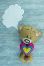 Valentines Day postcard. Teddy bear on wooden background.