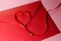 Valentine`s Day of St.Valentine Day envelope and ribbon of red color heart shape from a ribbon Royalty Free Stock Photo