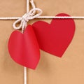 Valentines day red heart shape gift tag, brown paper package parcel background Royalty Free Stock Photo