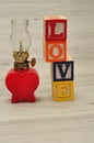 A red oil lamp in the shape of a heart with love