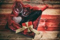 Valentines day. Red wine bottle, glasses and a gift in a box, wooden background Royalty Free Stock Photo