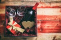 Valentines day. Red wine bottle, glasses and a gift in a box, wooden background Royalty Free Stock Photo