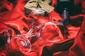 Valentines day. Red wine bottle, glasses and a gift on red satin Royalty Free Stock Photo