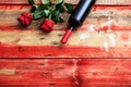Valentines day. Red wine bottle, glasses and roses on wooden background Royalty Free Stock Photo