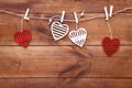 Valentines day romantic background, red and white handmade wood toy decorative hearts hanging on brown wooden table, happy holiday Royalty Free Stock Photo