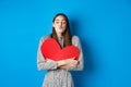 Valentines day. Romantic beautiful woman close eyes and pucker lips for kiss, holding big red heart cutout, kissing you Royalty Free Stock Photo