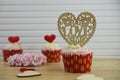 Valentines day romantic cup cakes in strawberry and cream flavor with big love heart decoration on top Royalty Free Stock Photo