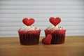 Valentines day romantic cup cakes in strawberry and cream flavor with red love heart decorations on top Royalty Free Stock Photo