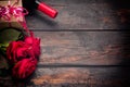 Valentines day romantic greeting card. Red rose flowers, wine bottle and gift box on wooden table. Free space Royalty Free Stock Photo