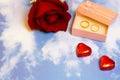 valentines day rose chocolates and rings in a box on a sky background pattern Royalty Free Stock Photo