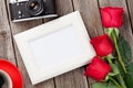 Valentines day roses, photo frame and camera Royalty Free Stock Photo