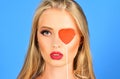 Valentines Day. Sensual woman with red heart. Fashion model with long blonde hair.