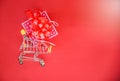 Valentines day shopping and Gift Box Pink present box with red ribbon bow on shopping cart concept Merry Christmas Holiday Happy Royalty Free Stock Photo