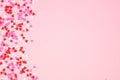 Valentines Day side border with candy heart sprinkles over a pink background with copy space Royalty Free Stock Photo