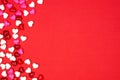 Valentines Day side border of candy hearts over a red background with copy space Royalty Free Stock Photo