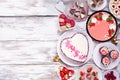 Valentines Day side border with a selection of desserts and sweets over a white wood background Royalty Free Stock Photo
