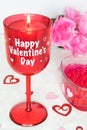 Valentines Day still life with red glass, candle, and pink roses. Romantic Concept on white soft background Royalty Free Stock Photo