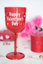 Valentines Day still life with red glass, candle, and pink roses. Romantic Concept on white soft background Royalty Free Stock Photo