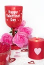 Valentines Day still life with red glass, candle, and pink roses. Romantic Concept on white soft background Royalty Free Stock Photo