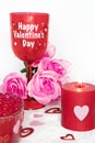 Valentines Day still life with red glass, candle, and pink roses. Romantic Concept on white soft background Royalty Free Stock Photo