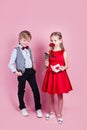 Valentines day surprise. Little boy in love giving cute girl red rose Royalty Free Stock Photo