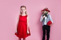 Valentines day surprise. Little boy in love giving cute girl red rose Royalty Free Stock Photo