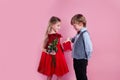 Valentines day surprise. Little boy in love giving cute girl red rose , Royalty Free Stock Photo