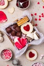 Valentines Day sweets and cookies in wooden box. Chocolate, candy, meringue, marshmallow, linzer cookies, gingerbread. Royalty Free Stock Photo