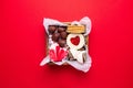 Valentines Day sweets and cookies in wooden box on red background. Chocolate, meringue, marshmallow, linzer cookies, gingerbread. Royalty Free Stock Photo