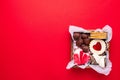 Valentines Day sweets and cookies in wooden box on red background. Chocolate, meringue, marshmallow, linzer cookies, gingerbread. Royalty Free Stock Photo