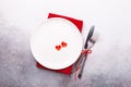 Valentines day table place setting with red hearts and silverware on stone background. Top view. Valentine`s card Royalty Free Stock Photo