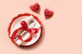 Valentines day table place setting with red rose, two hearts. Royalty Free Stock Photo