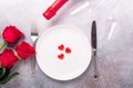 Valentines day table setting with bouquet of roses, red roses and champagne glasses on stone background. Top view. Valentine`s Royalty Free Stock Photo