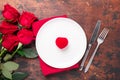 Valentines day table setting empty plate, red roses and velvet ring box on wooden background. Top view. Valentine`s greeting card Royalty Free Stock Photo