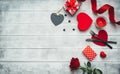 Valentines day table setting with fork, knife, red hearts, ribbon and roses. Royalty Free Stock Photo